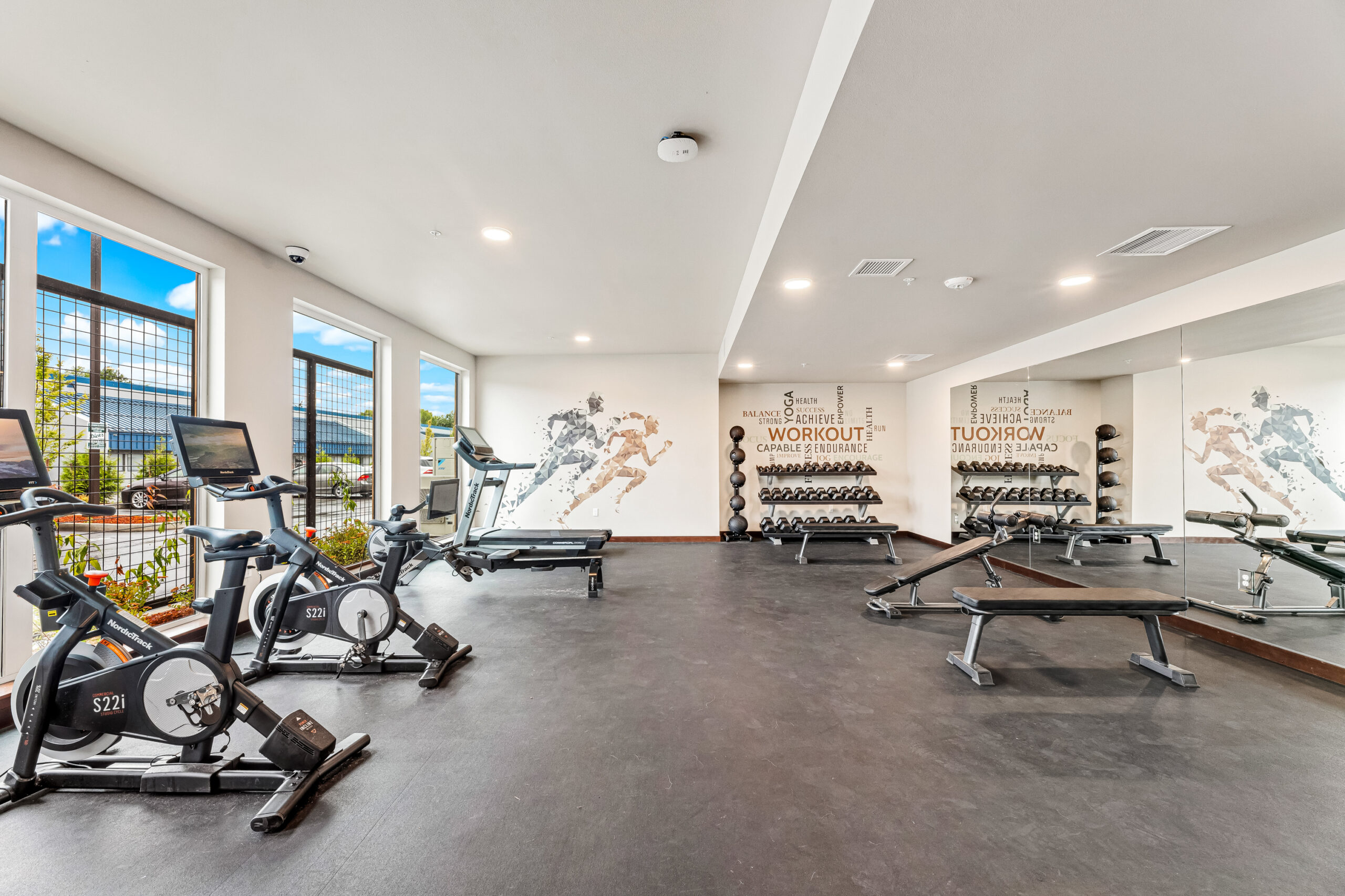 2 Bedroom Luxury Apartments in Arlington WA - Pilchuck Village - Fitness Center with Bike Machines, a Treadmill, Benches, & Dumbbells