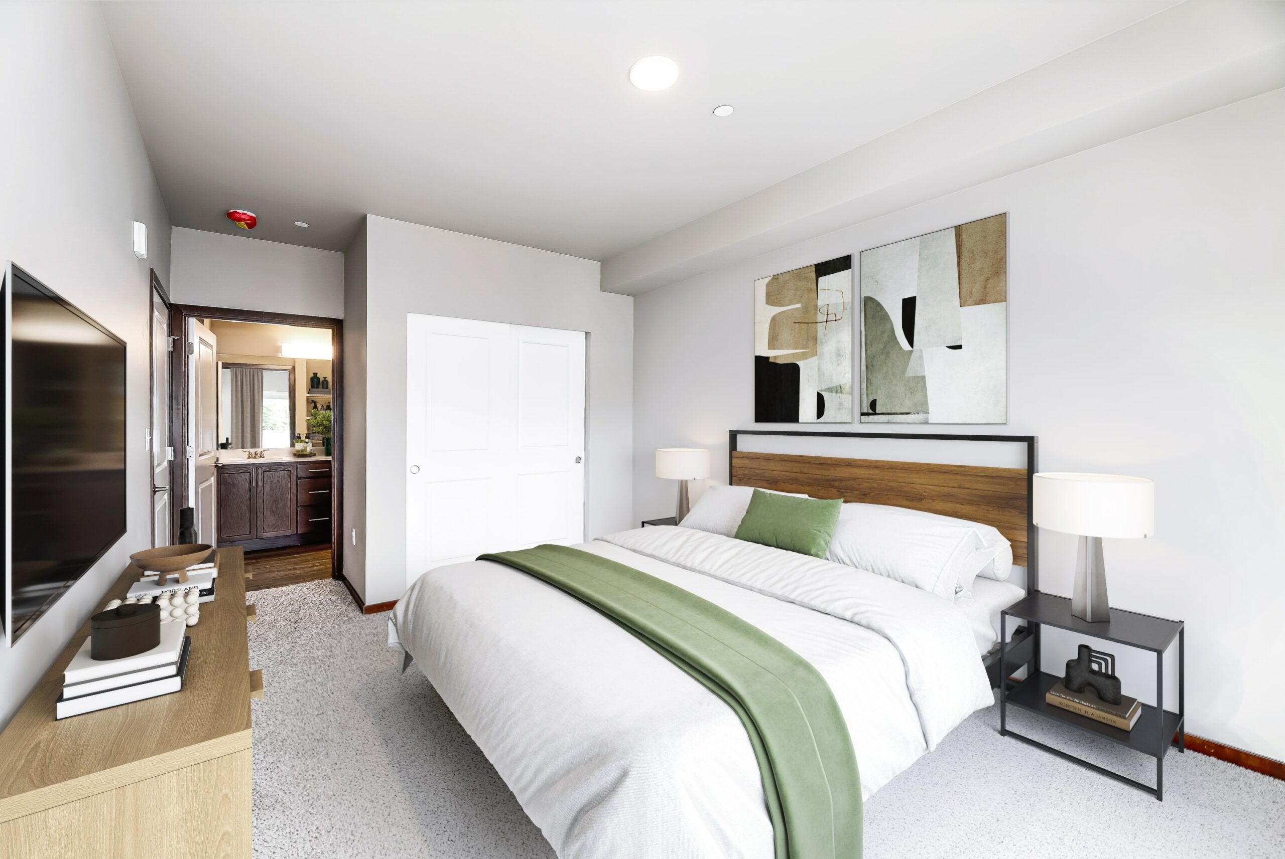 1 Bedroom Luxury Apartments in Arlington WA - Pilchuck Village - Bedroom with Plush Carpet, Connected Bathroom, and a Closet with Sliding Doors