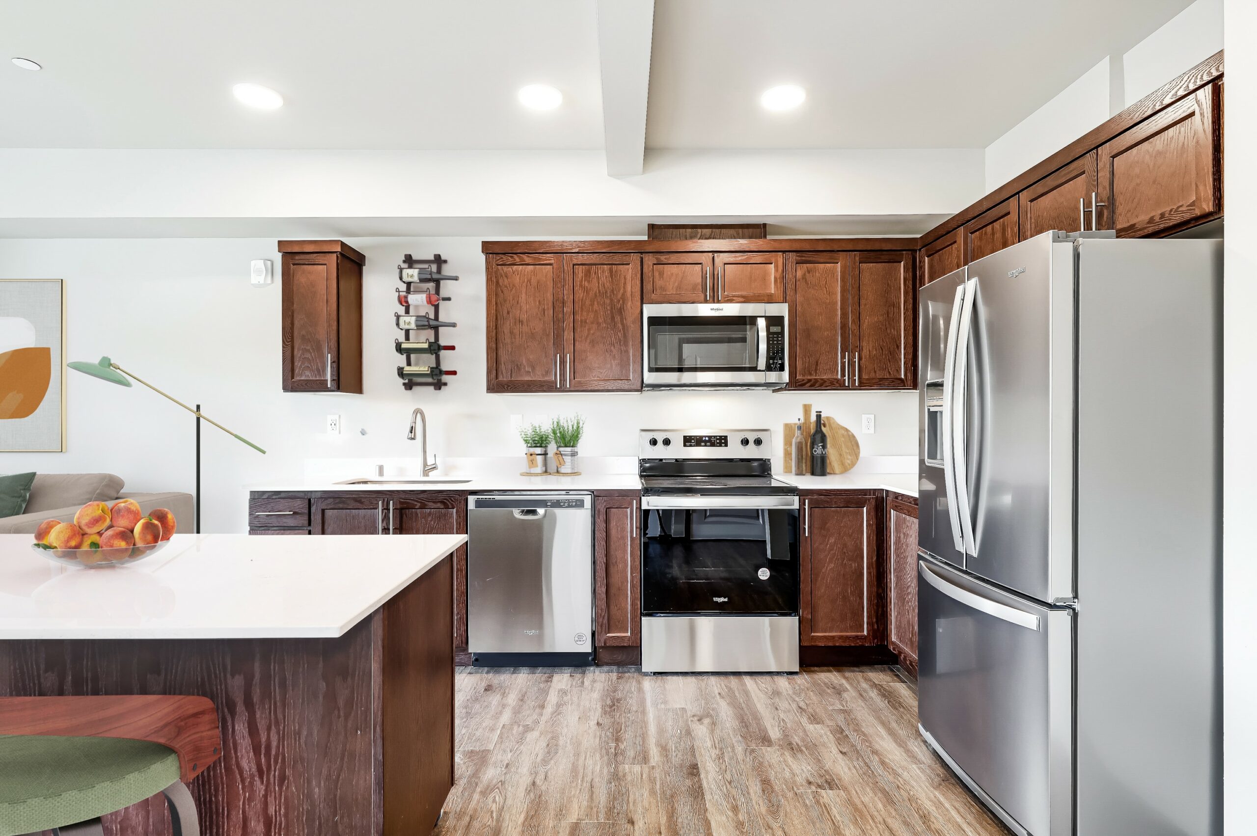 One Bedroom Luxury Apartments in Arlington WA - Pilchuck Village - Kitchen with Stainless Steel Appliances, White Quartz Countertops, & Dark Wood Cabinets